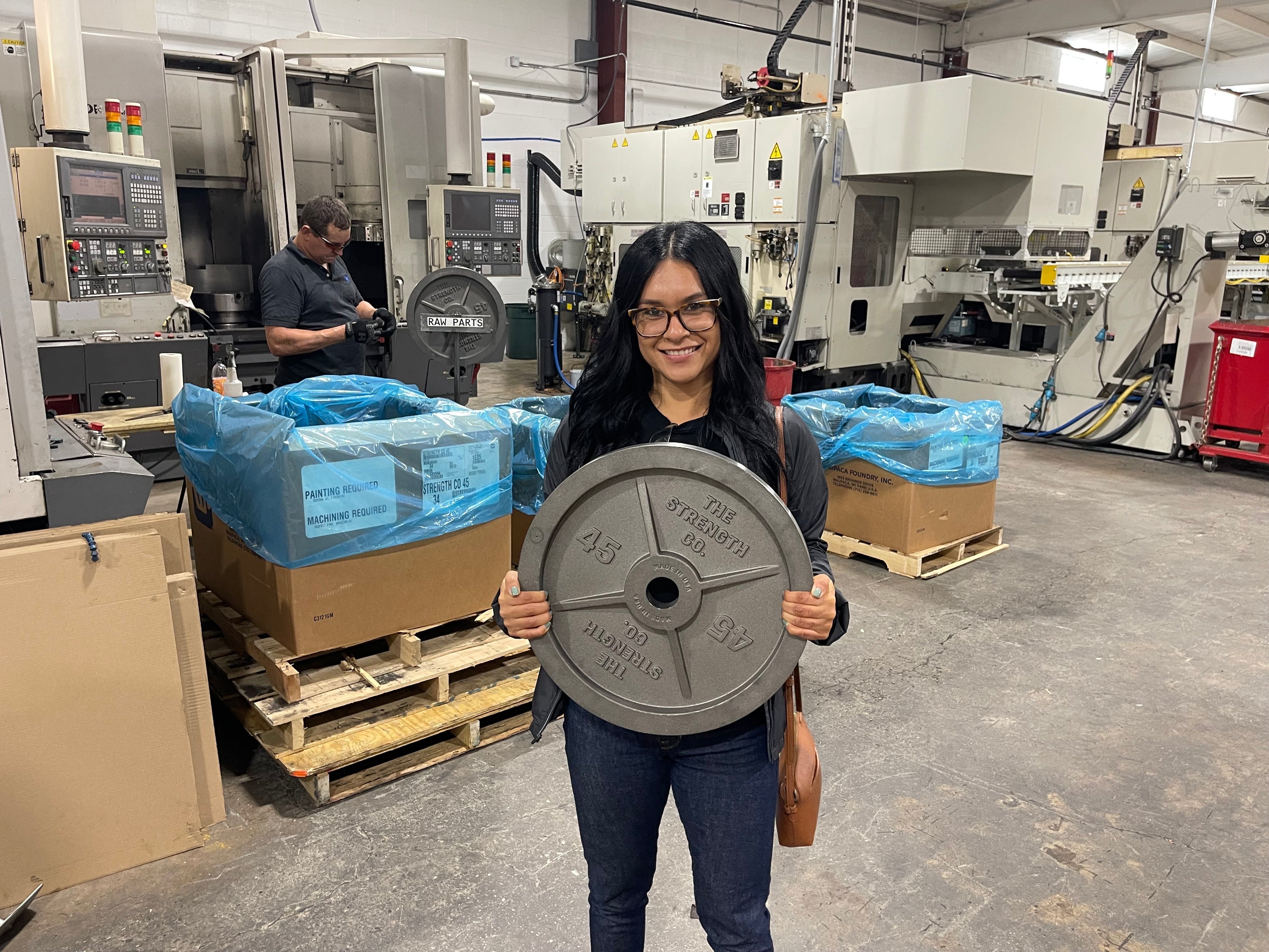 A raw machined Strength Co. 45 lb plate on the shop floor