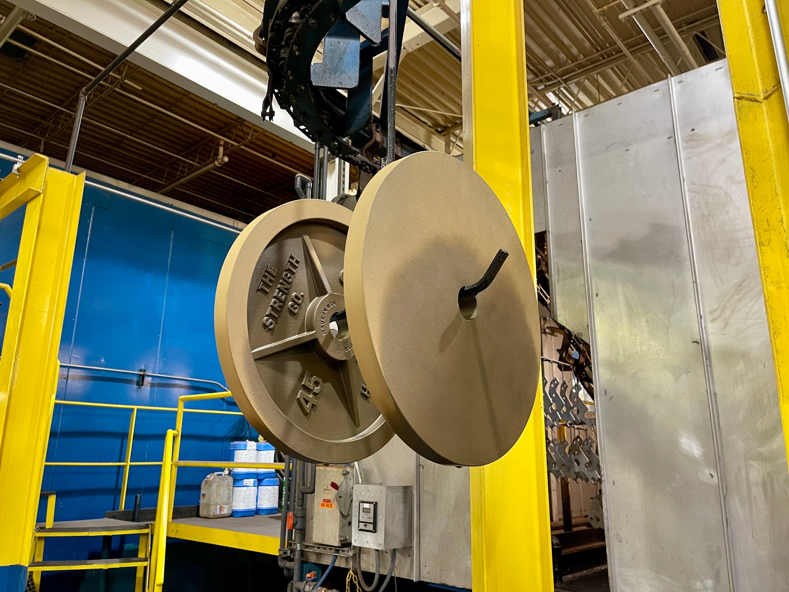 Strength Co. plates moving through the e-coat finishing line