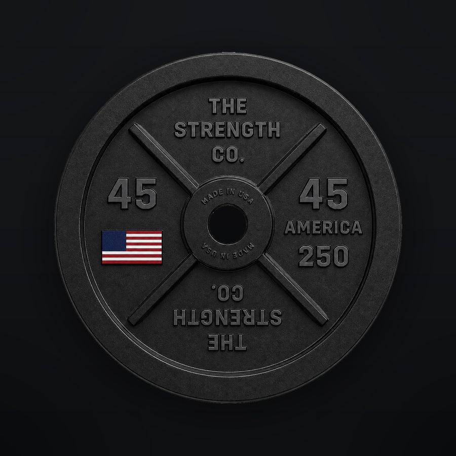 The Strength Co. America 250 black cast iron 45 lb plate with a colorized American flag on a black background